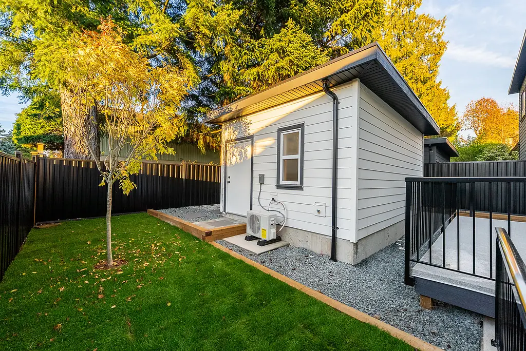 Back yard with garden suite and young tree